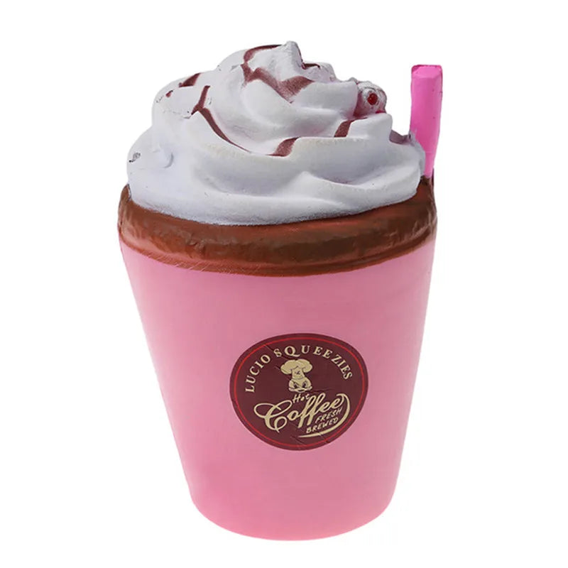 A pink cup filled with a whipped cream topping and a brown drink, featuring a logo for Lucio Squeezies Brewed.