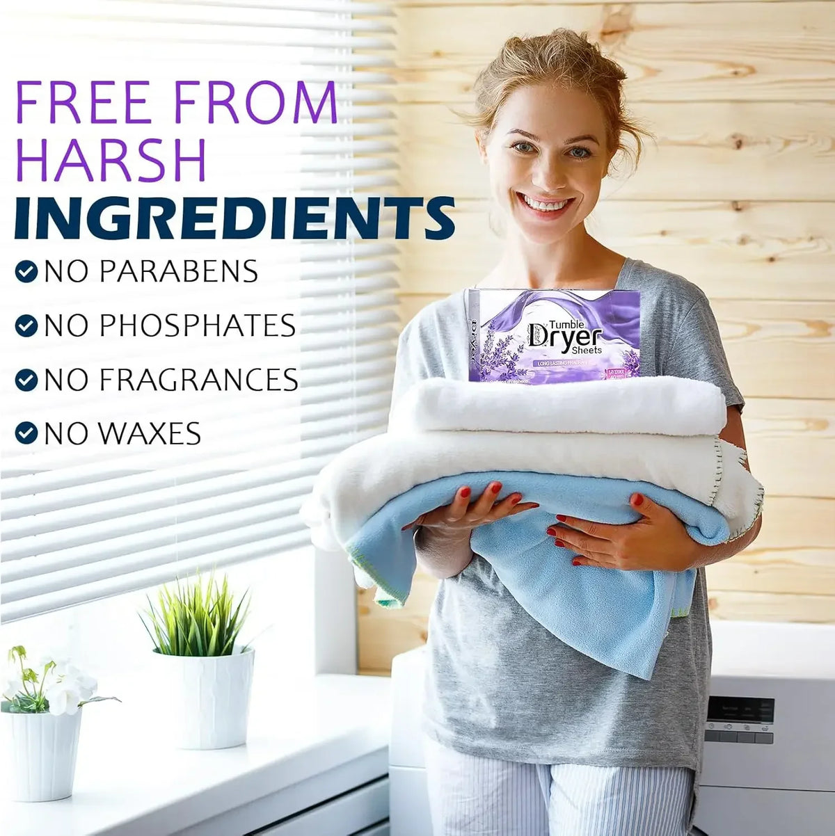 A smiling woman holds a bundle of lavender dryer sheets in front of a window with wooden blinds.