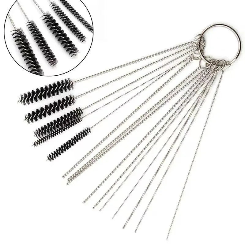 A set of carburetor cleaning tools including jet needles and brushes hanging from a metal ring.