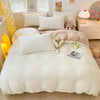 A cozy milk velvet bedding set featuring a duvet cover and several white pillows in a bright room.