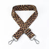 A brown leopard print wide adjustable crossbody bag strap with silver hardware.