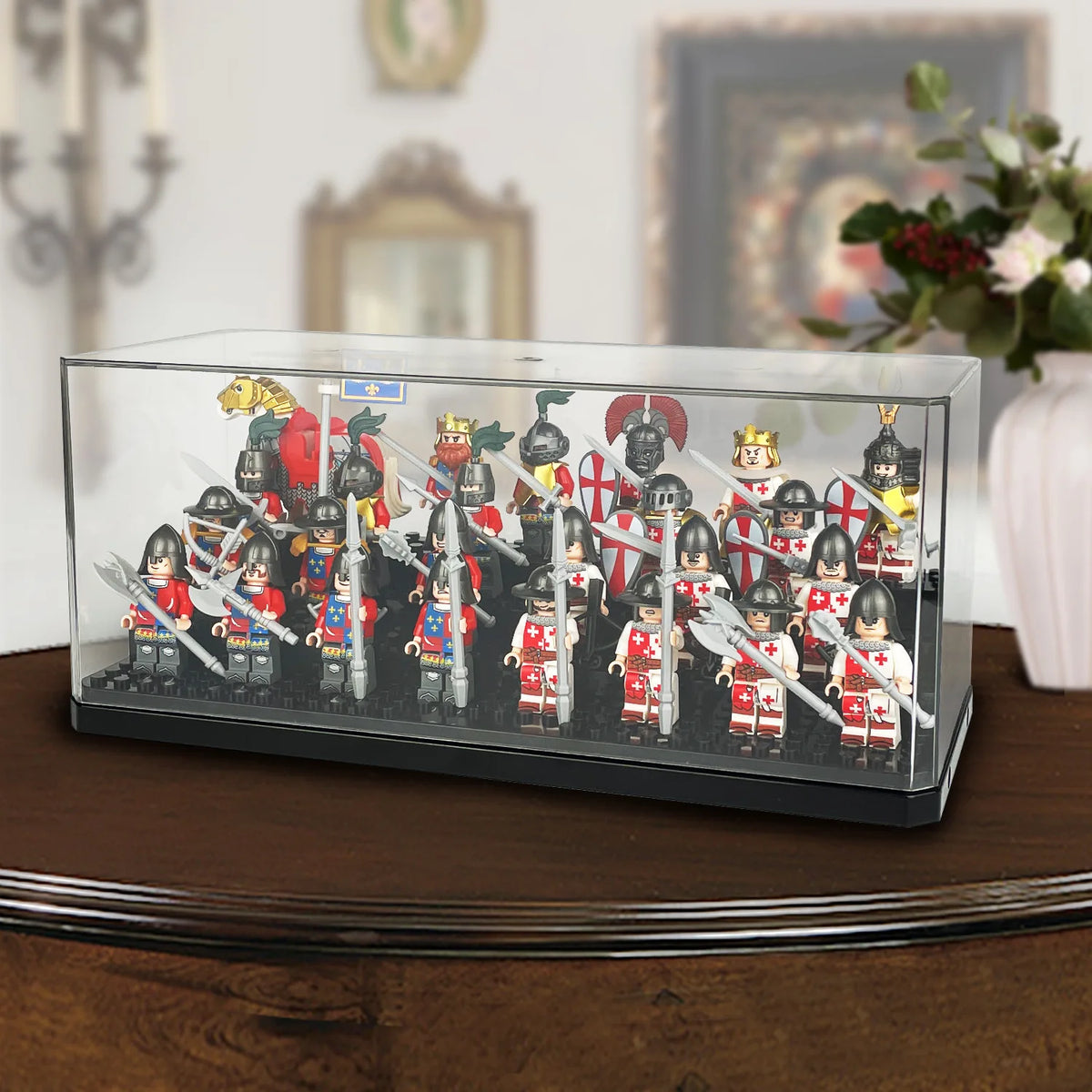 A clear acrylic display case holding a collection of miniature historical figurines and soldiers.