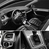 Interior view of a car showing the dashboard, steering wheel, and door panel details.