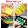 Yellow and green double-sided kitchen scouring pads being used for cleaning.