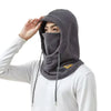 A person wearing a gray 3-in-1 winter balaclava with a mask and neck warmer, pulled up over their face.