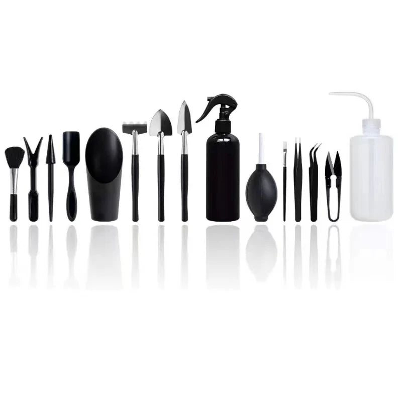 A collection of black succulent and bonsai gardening tools including pliers, tweezers, and a spray bottle.