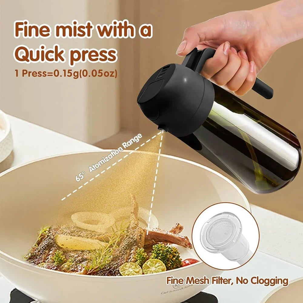 A hand is squeezing a dark glass olive oil sprayer, demonstrating the fine mist produced for seasoning food.
