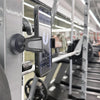 A black magnetic phone holder is attached to a gym equipment bar, displaying a workout screen.