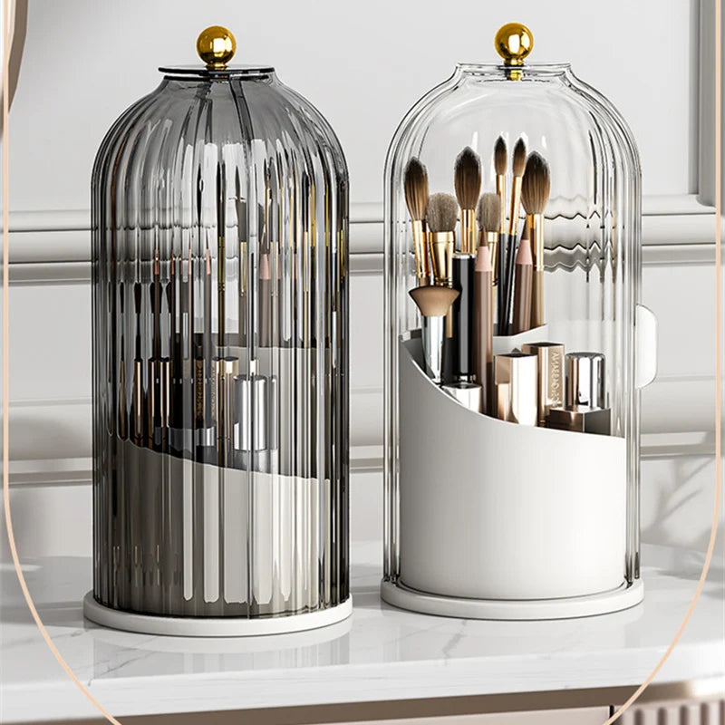 A clear glass organizer for makeup brushes with a rotating lid, featuring various tools in a modern design.