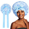 A woman wearing a light blue satin silk sleep bonnet tied with a bow.