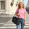 Two women model a medium tote bag in pink and a beige color on a city street.