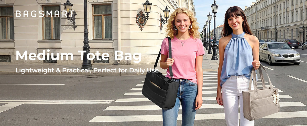 Two women model a medium tote bag in pink and a beige color on a city street.
