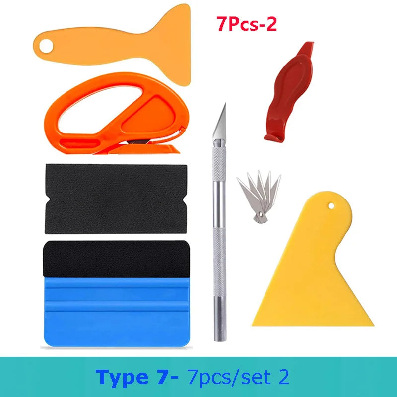 A set of seven vinyl wrap and film application tools including orange and red tools, a knife, and various black, blue, and ye