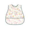 A light pink baby feeding bib with a floral pattern and a catch pocket.