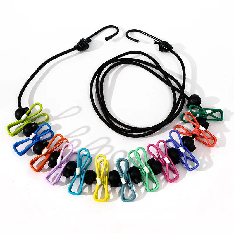 A travel clothesline with 12 colored clips for indoor and outdoor drying, featuring black cords.