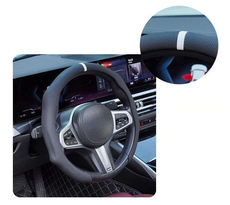 Close-up view of a black steering wheel with silver accents and a white accent stripe on the rim.