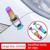 A close-up of a colorful modified body kit clip used for securing car parts.