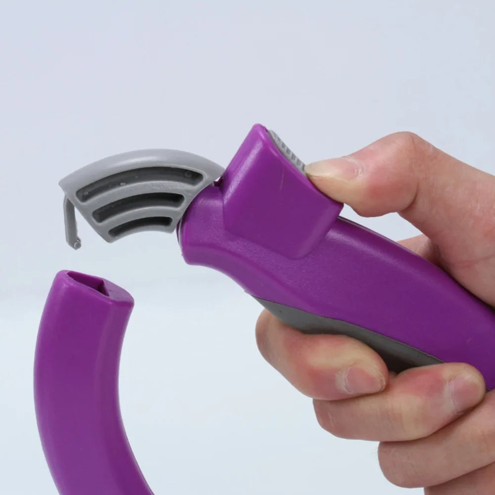 A hand holds a purple ergonomic grocery bag carrier with a gray handle, showing the device's design.