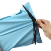 A hand is sealing a light blue heavy-duty waterproof poly mailer bag for shipping or storage.