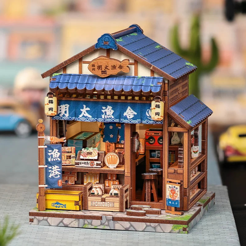 A detailed miniature wooden Japanese book nook kit featuring a shop facade and lighting elements.