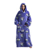 A woman wearing a purple oversized wearable blanket hoodie with a hood and sleeves, patterned with small bear graphics.