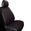 A close-up view of a black car seat cover featuring a quilted pattern with red stitching.