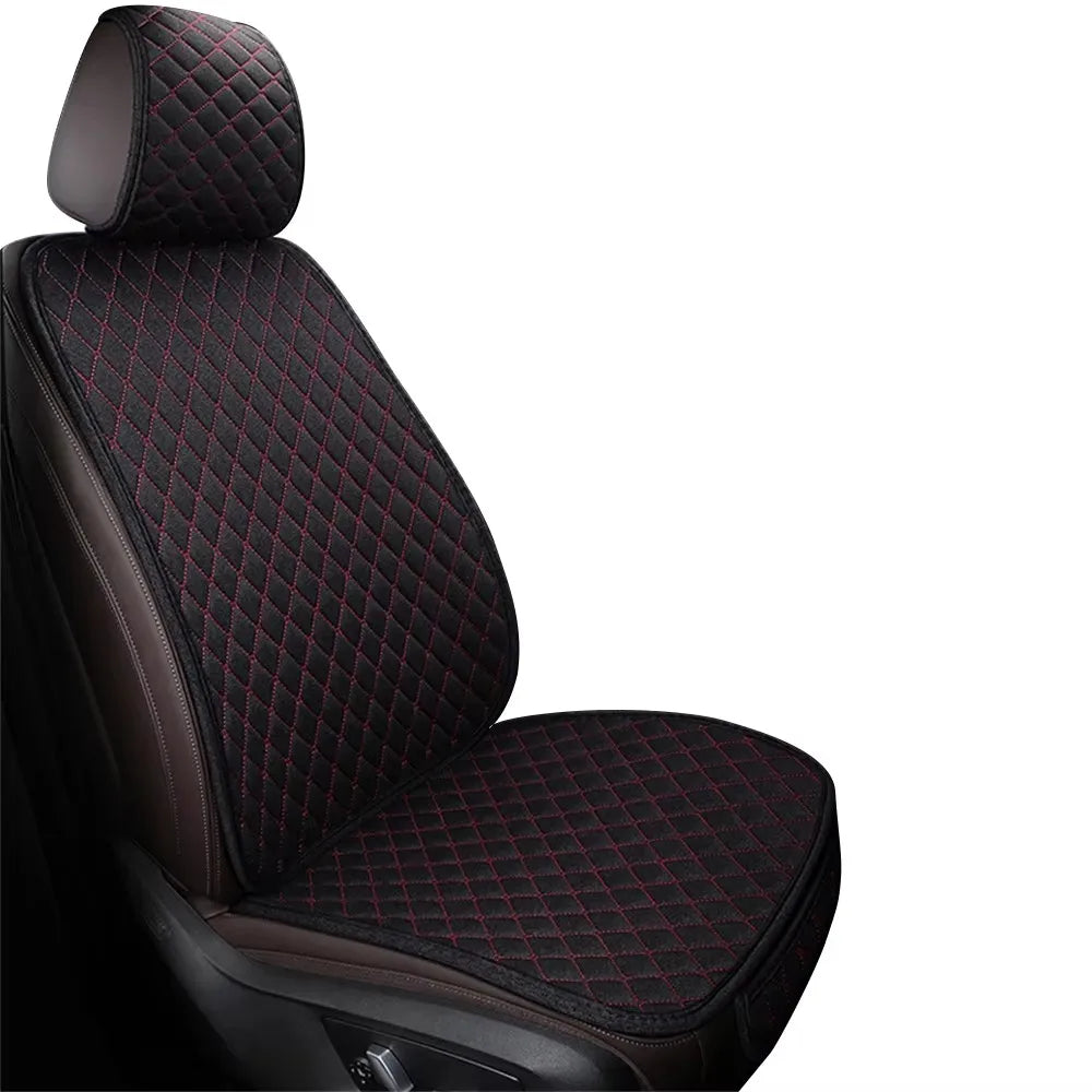 A close-up view of a black car seat cover featuring a quilted pattern with red stitching.