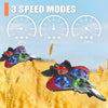 A black and red LED light foam stunt airplane is shown flying over a golden wheat field.