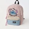 A pink fuzzy backpack featuring a Stitch graphic on the front.