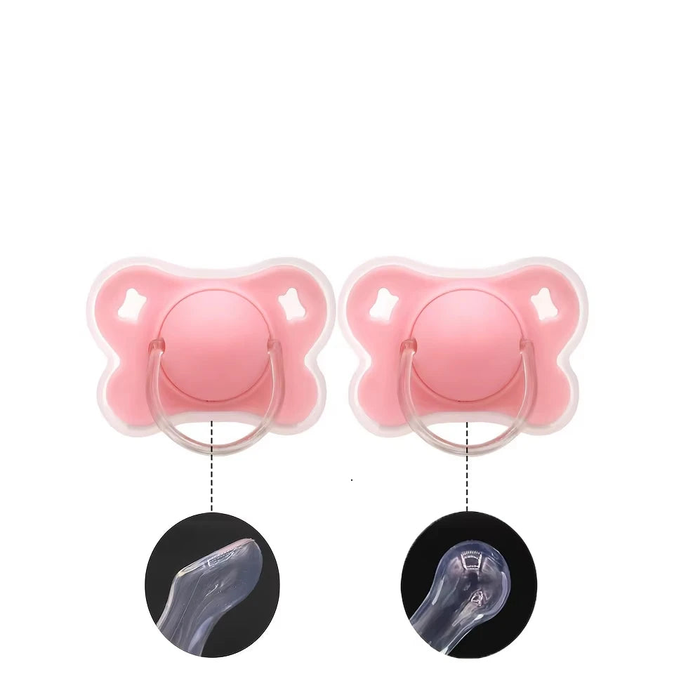 Pink silicone baby pacifier with a flower design and protective cover shown from the top and side.