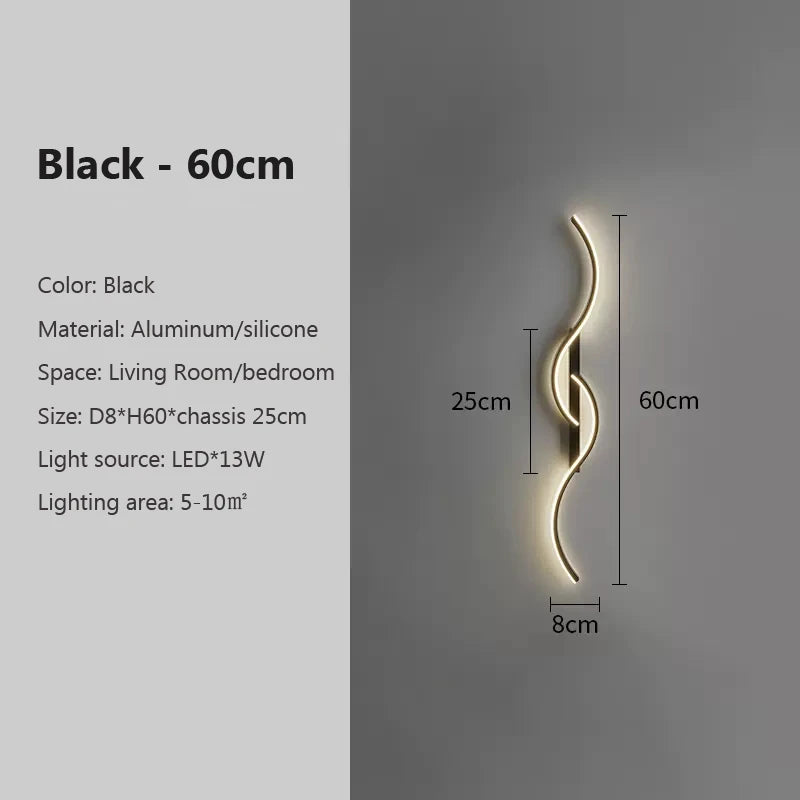 A black aluminum and silicone LED wall lamp with a curved design mounted on a gray wall.