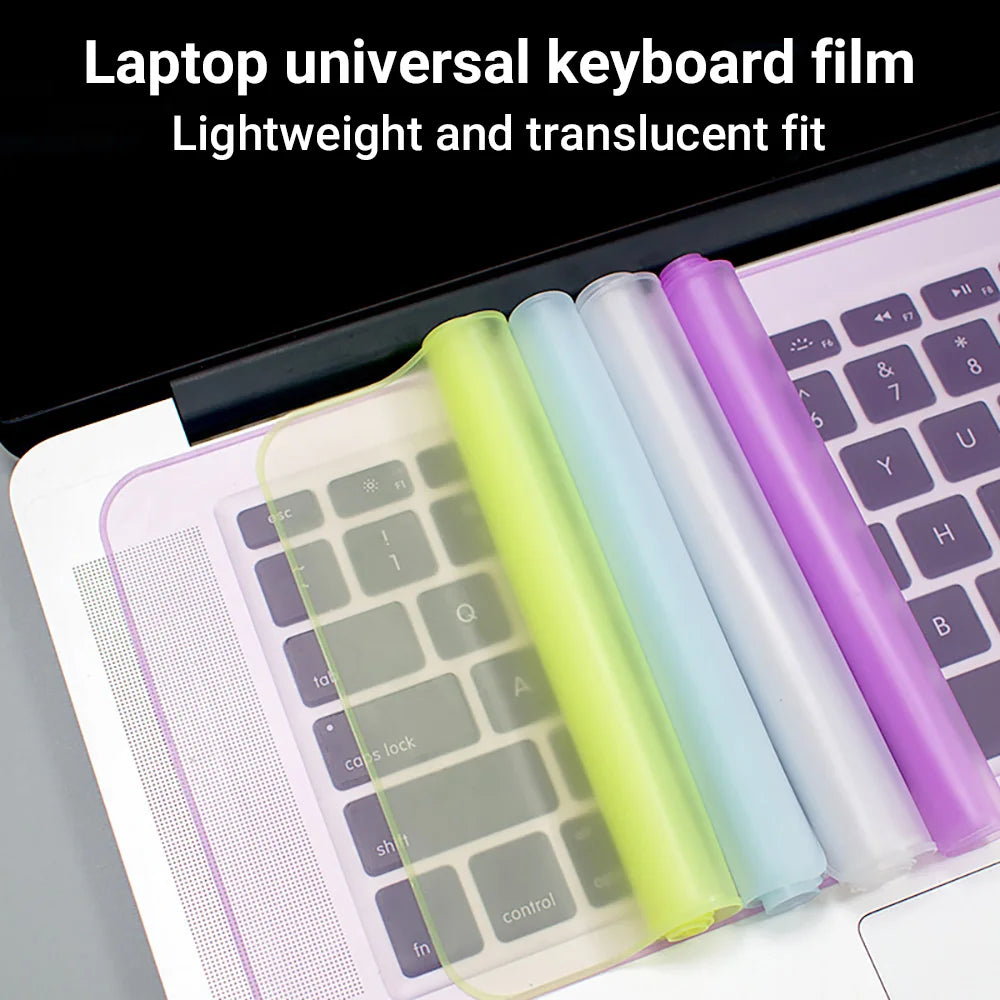 A set of lightweight, translucent silicone keyboard films in various colors fitted onto a laptop keyboard.