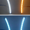 Two versions of LED daytime running lights, one white and one orange, mounted on a vehicle interior.