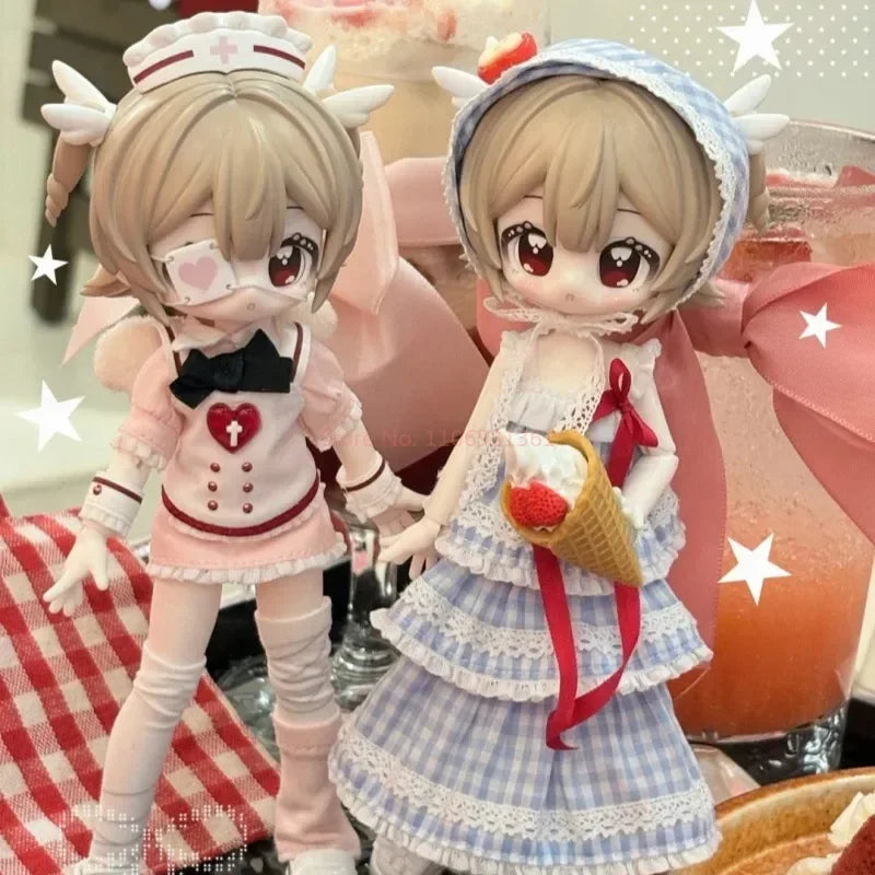 Two articulated BJD collectible figurines in pink and blue outfits with star accents displayed next to a glass of orange juic