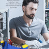 A man working on a laptop with various repair tools and electronics organized in a blue desktop rack.