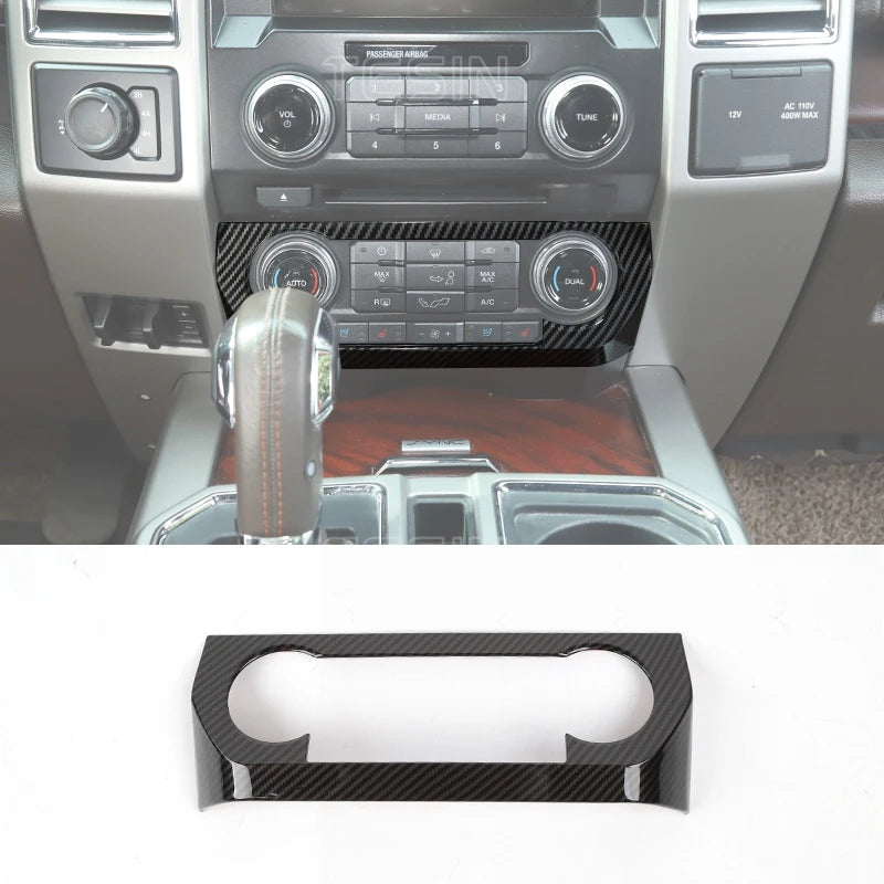 Black carbon fiber grain trim cover for a Ford F-150 center console.