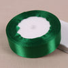Roll of lustrous satin ribbon in emerald green for gift wrapping and crafts