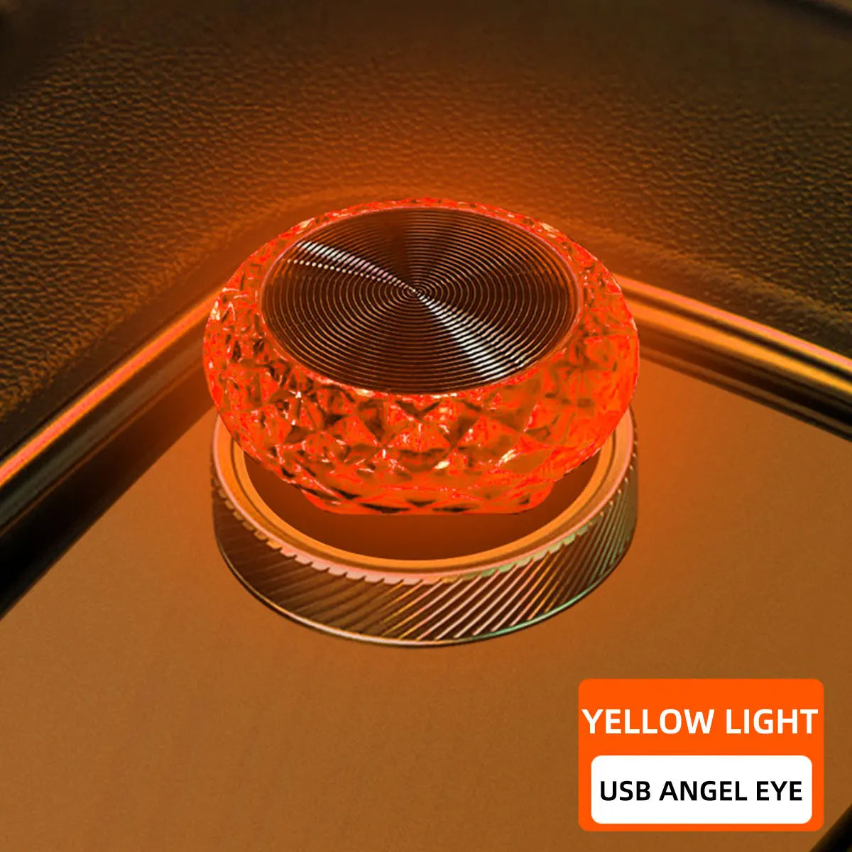 A small, orange-tinted LED light with a textured lens is shown illuminating a surface.