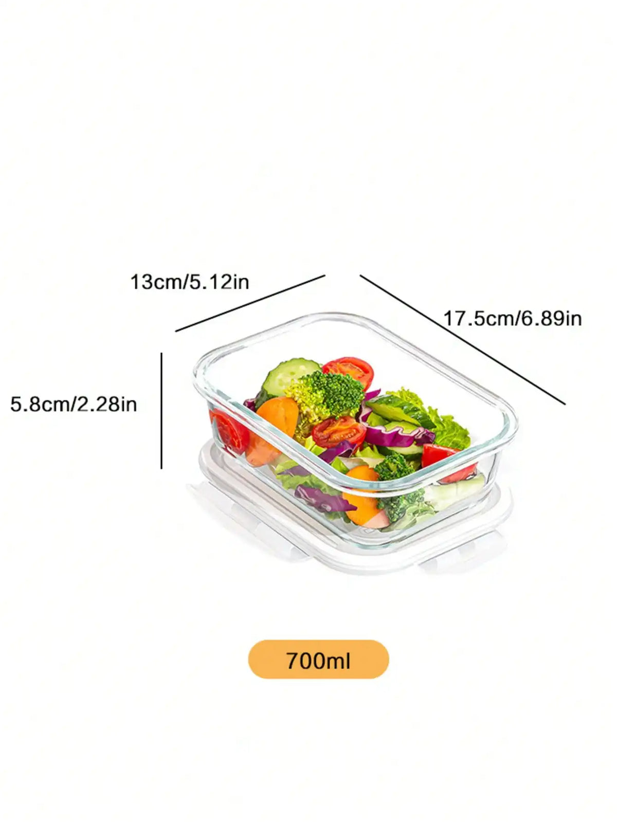A clear tempered glass food storage bowl with a lid filled with colorful vegetables like cucumbers, tomatoes, and broccoli.