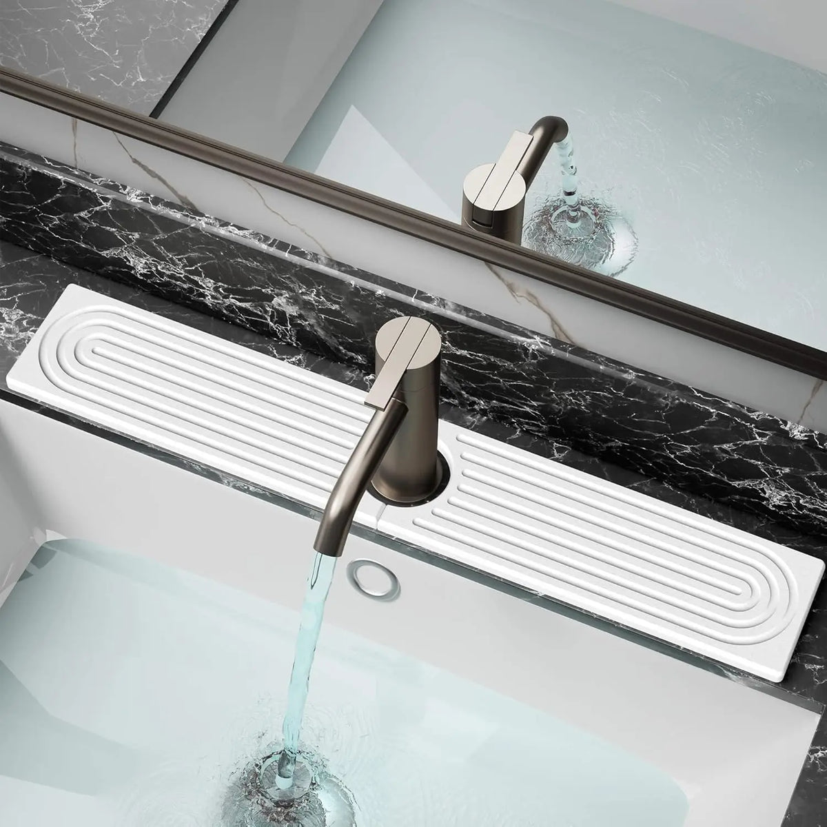 A modern faucet with a glass spout is shown over a white sink, featuring a stone tray for fast-drying water absorption.