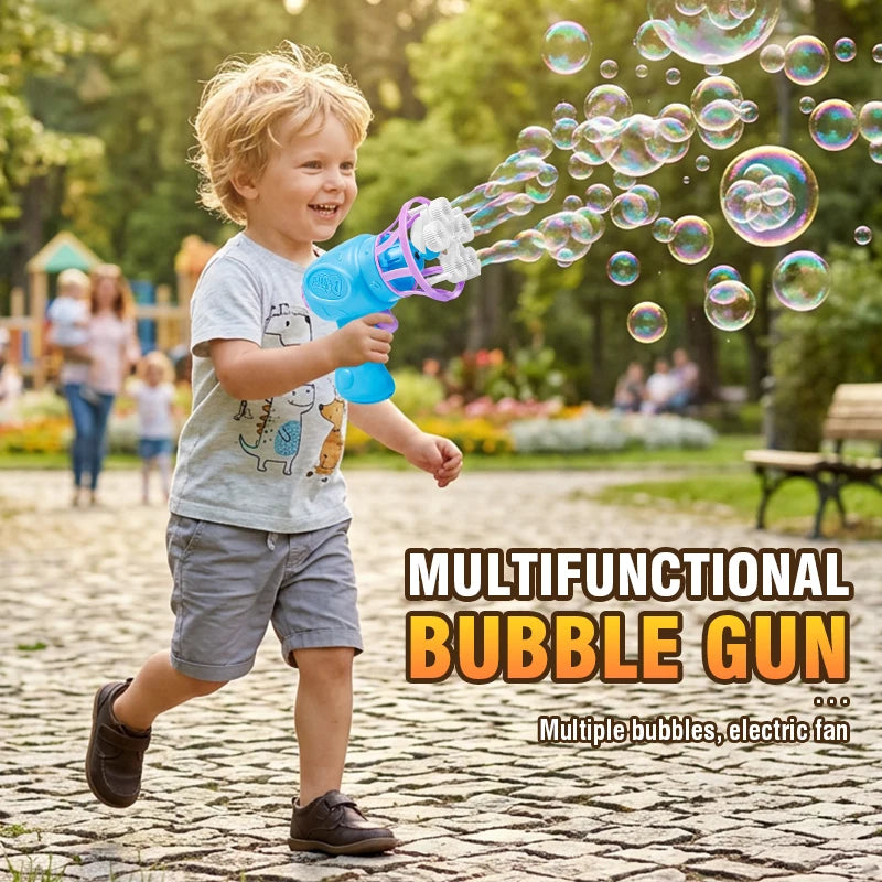 A young boy is playing with a blue bubble gun, shooting bubbles into the air in a park setting.