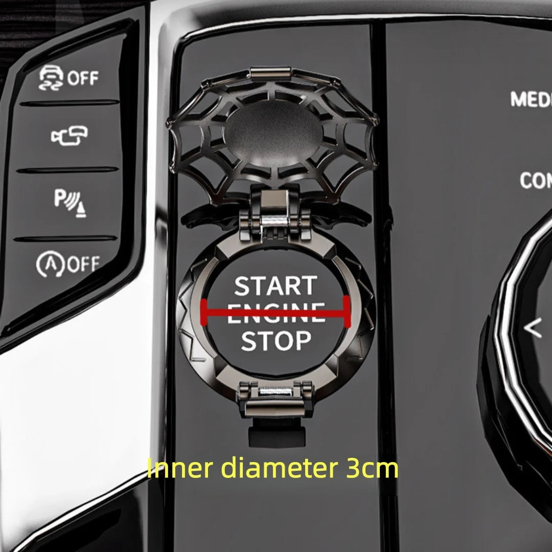 Close-up of a black metal push-start ignition button cover with a start engine stop mechanism and an inner diameter measureme