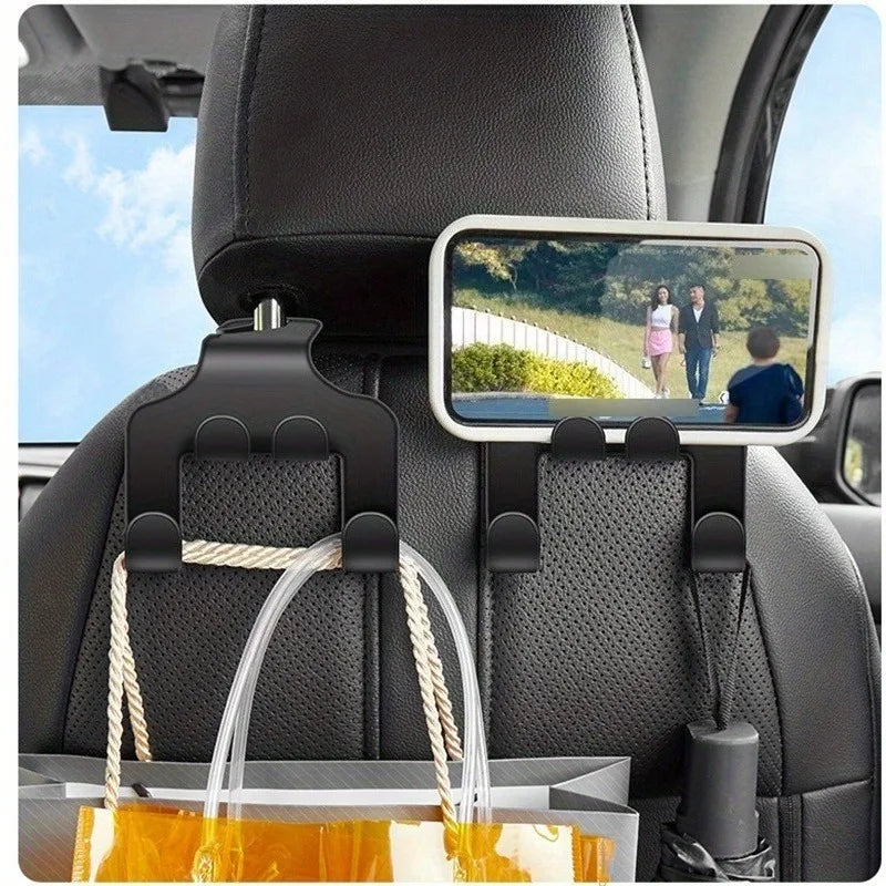 A black car seat phone holder with a mounted smartphone and an organizer hook visible in the back seat.