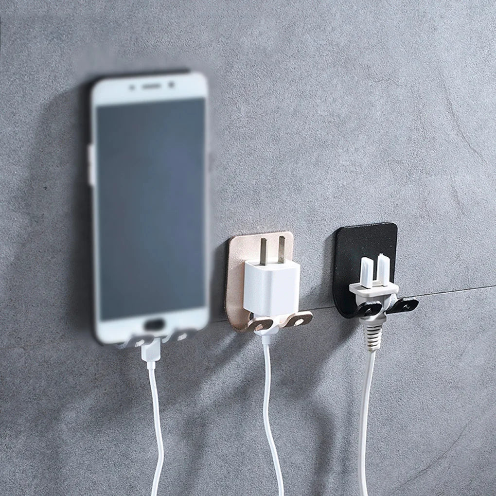 A white smartphone is mounted on a gray wall, connected to an aluminum wall-mounted adhesive razor holder.