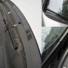 Close-up view of a flexible rubber windshield seal strip with various textured and perforated sections.