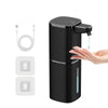 A black touchless infrared smart soap dispenser with a spout is shown next to its USB rechargeable battery and charging cable