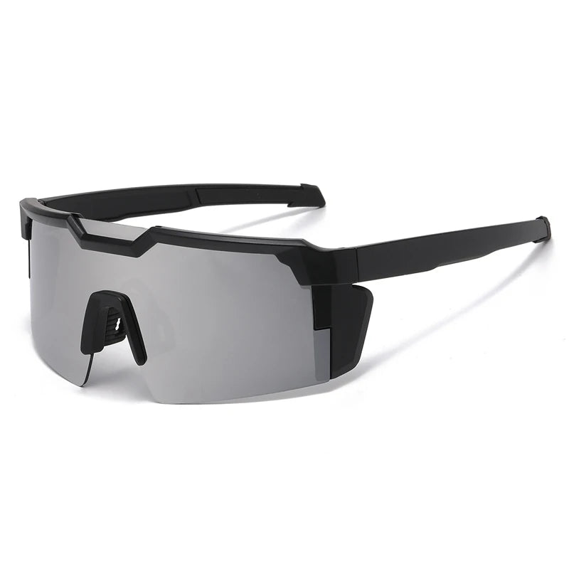 A pair of black sports sunglasses with gray lenses and a black frame are shown against a white background.