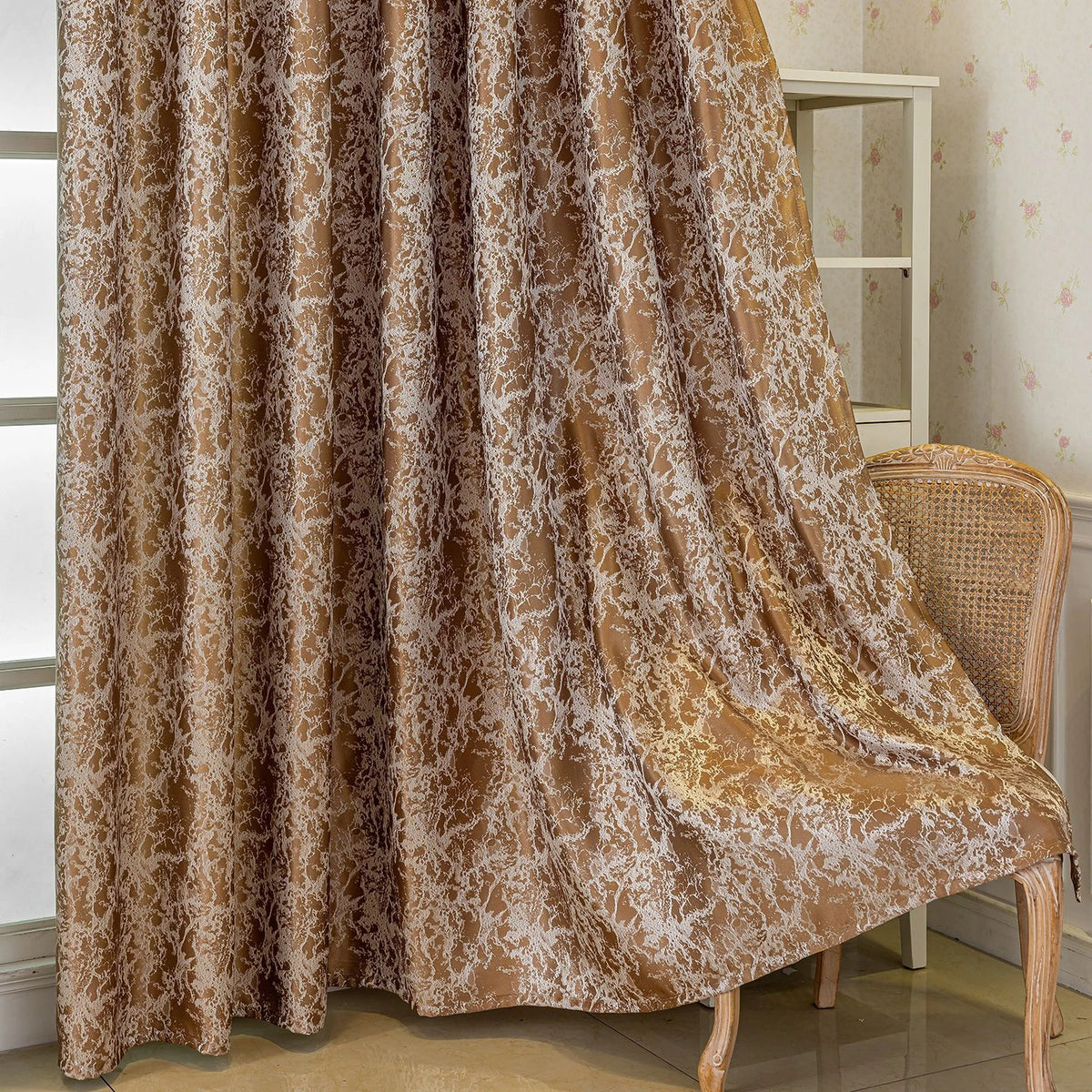 A floor-length brown and white patterned tree bark jacquard blackout curtain panel hanging next to a white shelving unit.