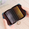 A hand holds an open brown accordion wallet with multiple card slots, demonstrating RFID protection.