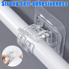 Close-up of a clear adhesive hook clamp attached to a white pole, demonstrating strong self-adhesiveness.